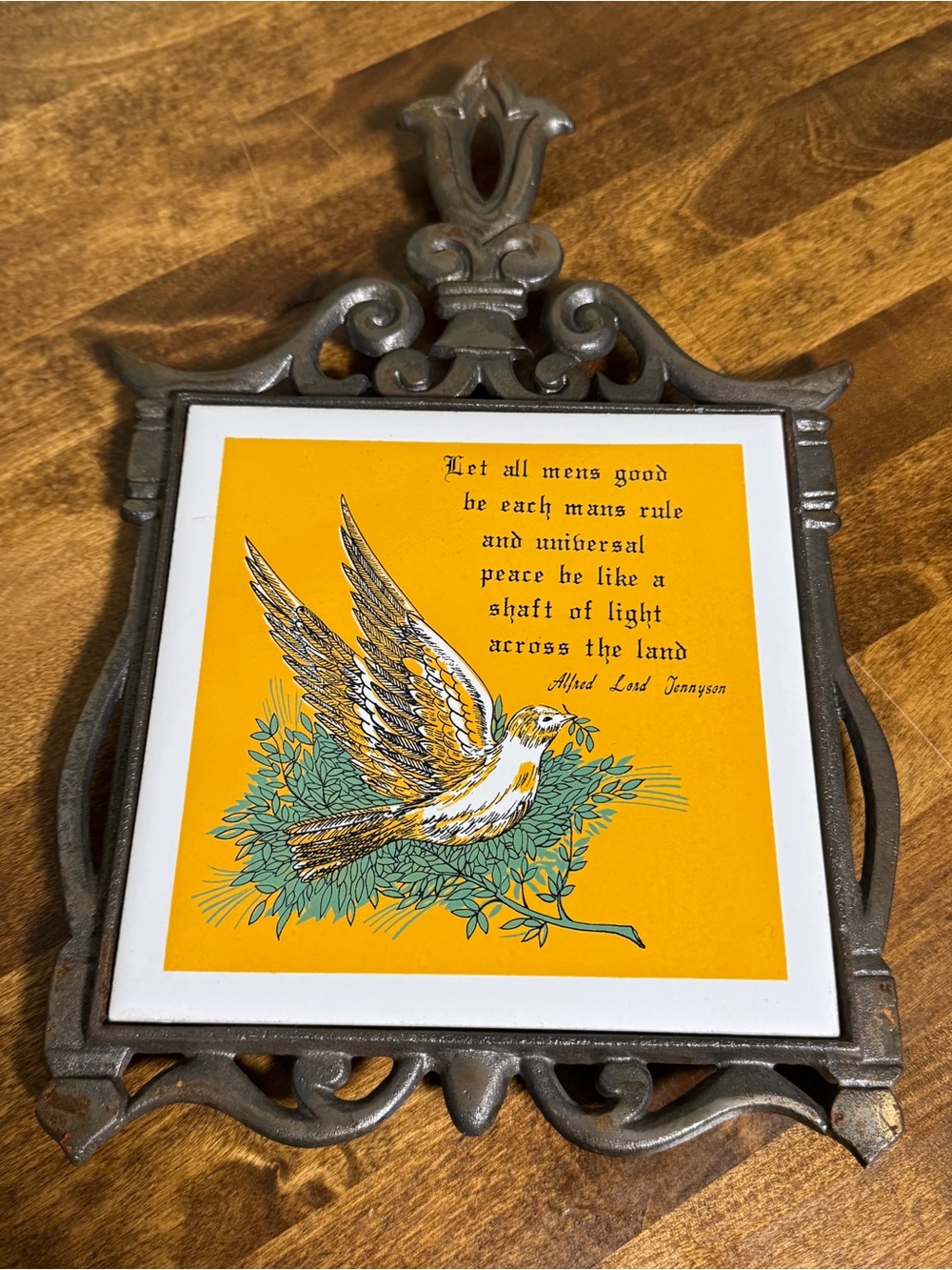 Vintage cast iron trivet tile with a dove and a quote from Alfred, Lord Tennyson
